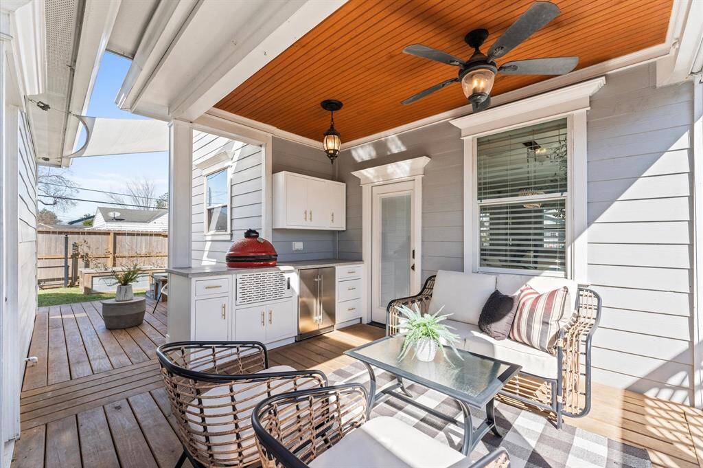 The best seat in the house might be outside. A built-in outdoor kitchen with beer & wine fridge, custom cabinetry, and shaded lounge area makes this patio the ultimate retreat.