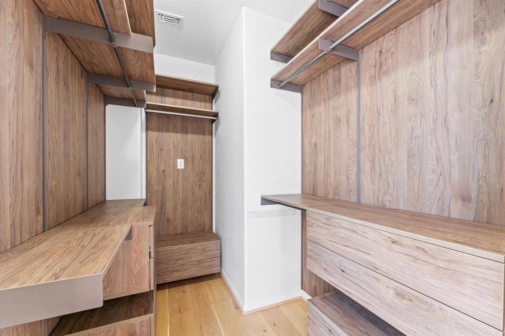 Closet envy, activated. Custom shelving, built-in drawers, and sleek organization make this walk-in feel like a personal boutique.