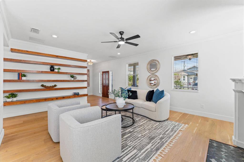 Custom floating shelves add warmth and personality, making this space feel both curated and completely livable.