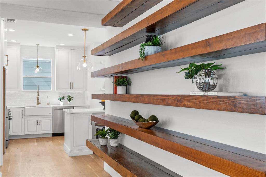 A home filled with character! These floating shelves create a seamless transition from the living area into the heart of the home—the kitchen.