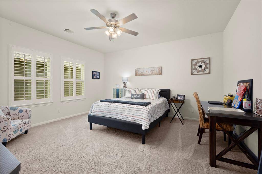 Large primary bedroom with natural light.