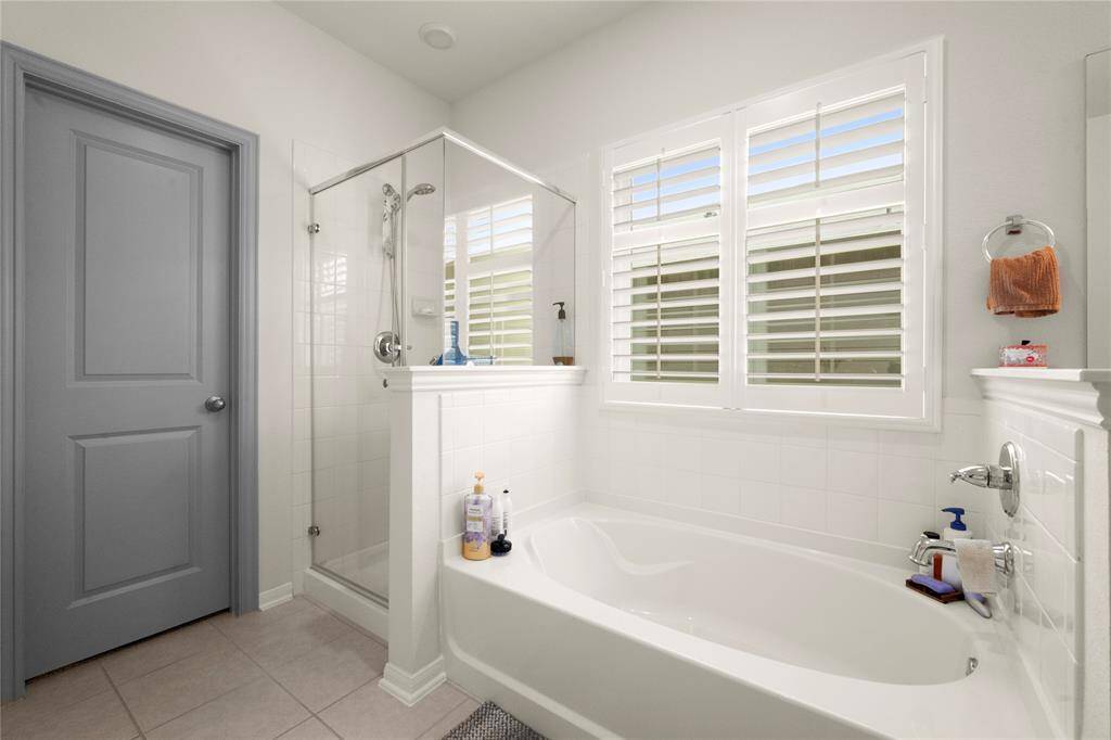 Shower with frameless glass doors.