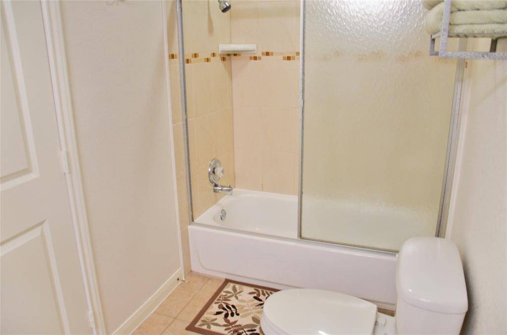 Laundry room with a washer and dryer located in the garage.