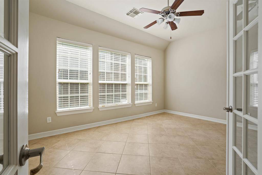 French doors open into sunny flex space with so many versatile uses!