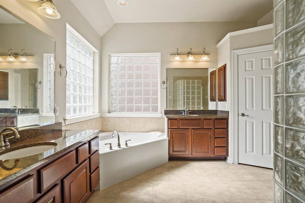 Ensuite bathroom features double sinks and a soaking tub.