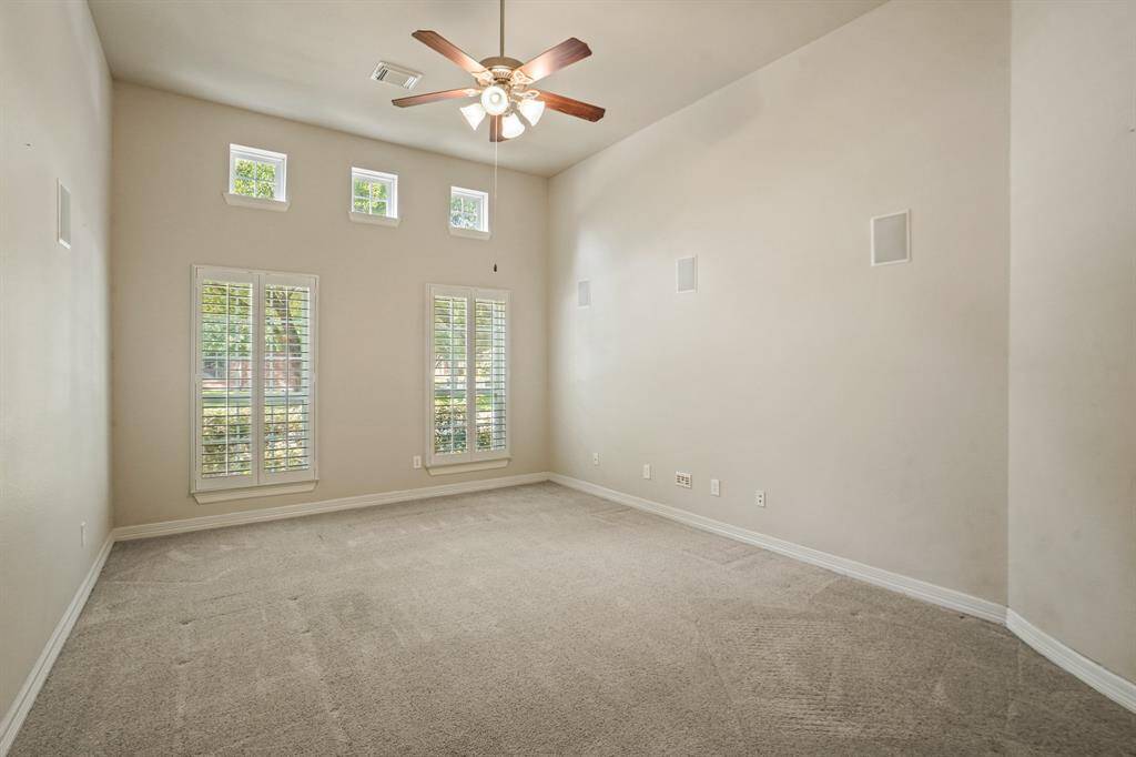 Tall ceilings are featured in this additional media room/flex space.