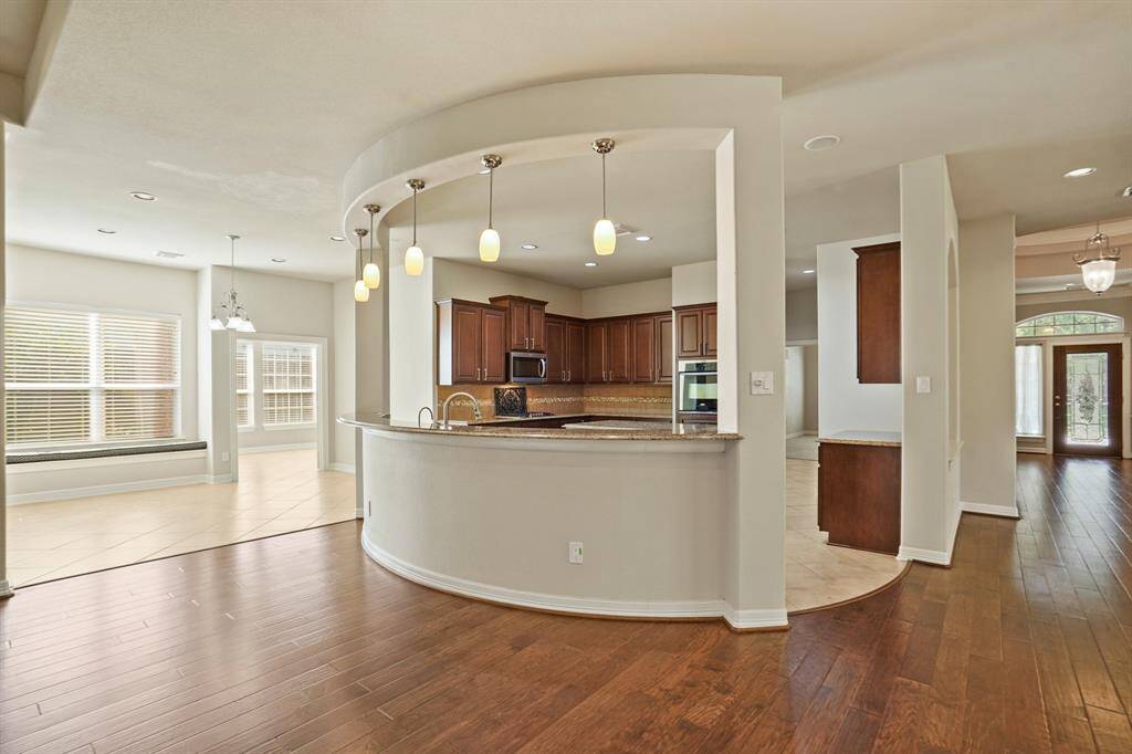 Kitchen features a bar overlooking the living area.