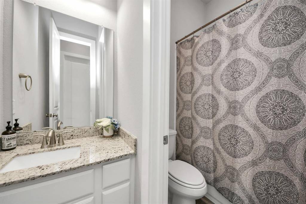 The secondary bath provides privacy for guests and family alike