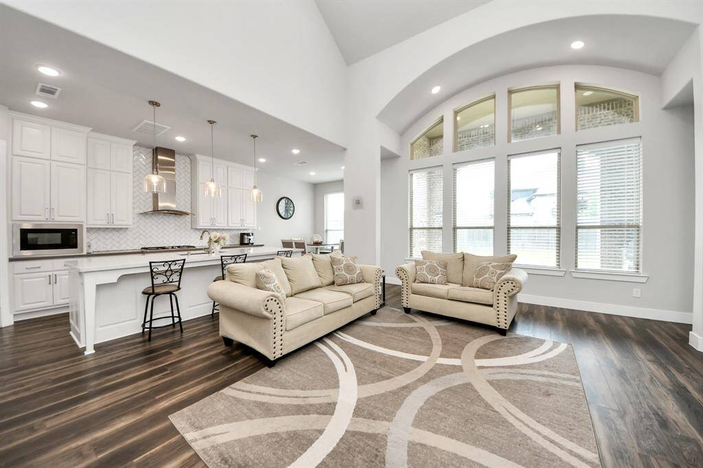 Gather the family and guests together in your lovely living room that features ceiling fan and large windows that provide plenty of natural lighting throughout the day...