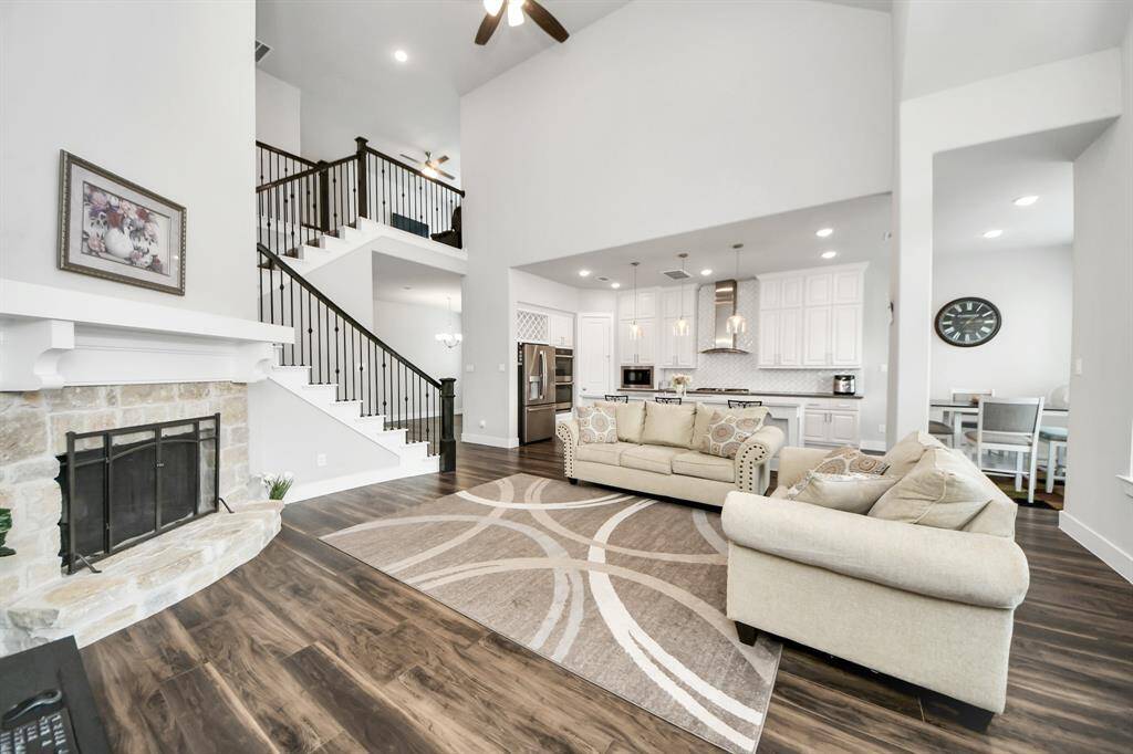 Another view of living room with beautiful fireplace.