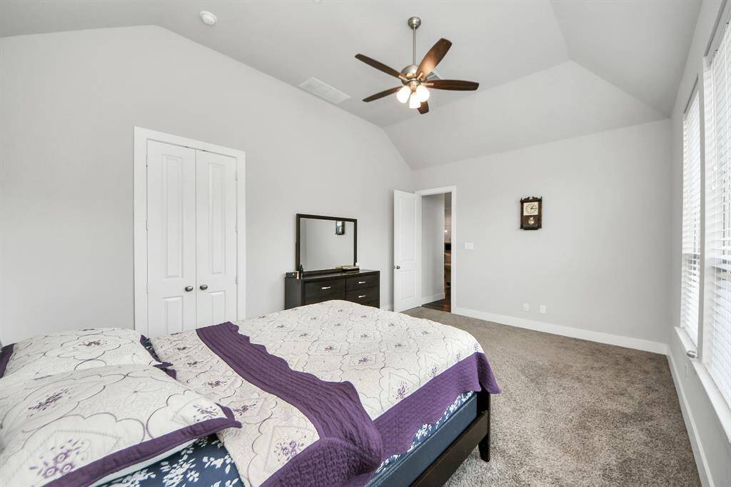 The stunning primary suite greets you with ceiling fan and large windows brightening up this spacious primary bedroom!