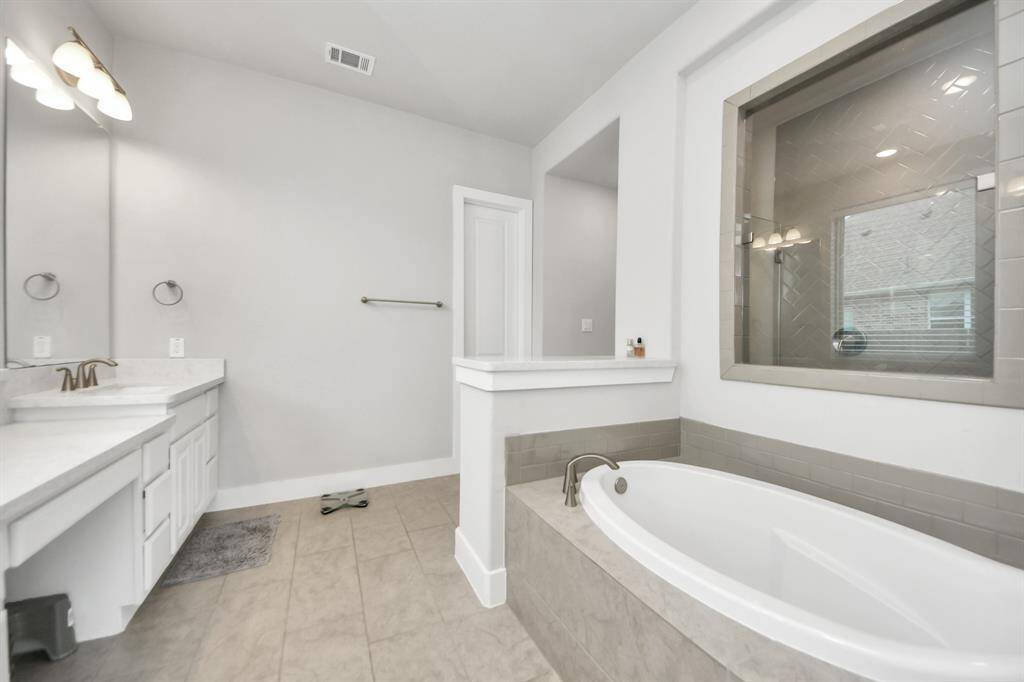 Relax in comfort in the primary bath in the large shower, it's the perfect space to unwind and rejuvenate after a long day