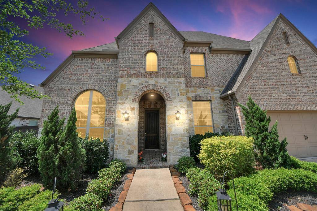 This home has charming curb appeal with a timeless brick and stone elevation.