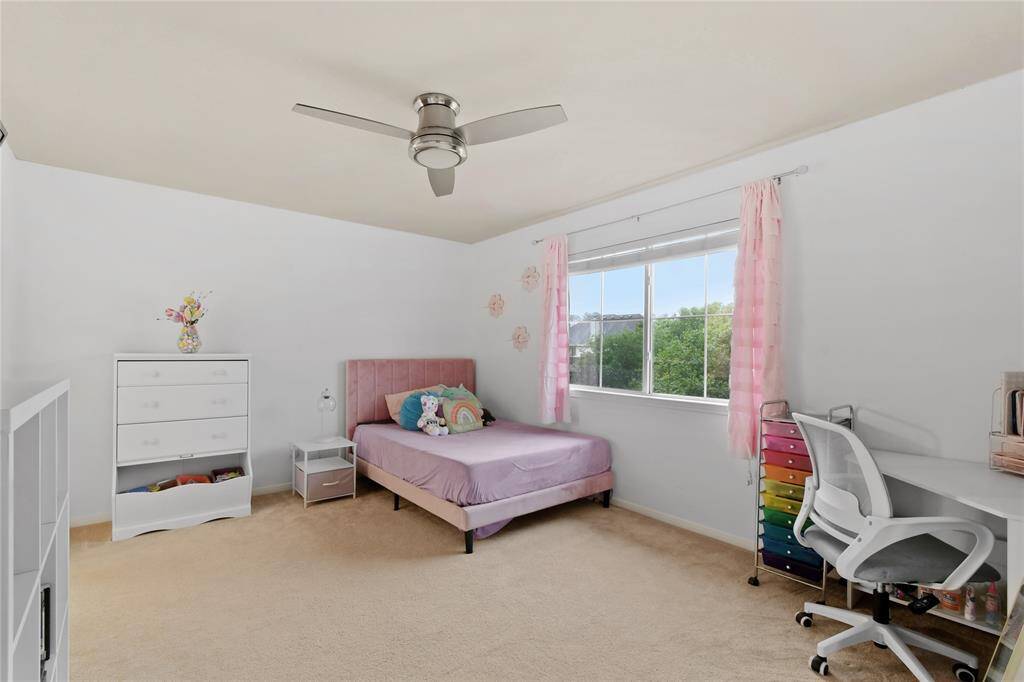 Another secondary bedroom with a pool view.