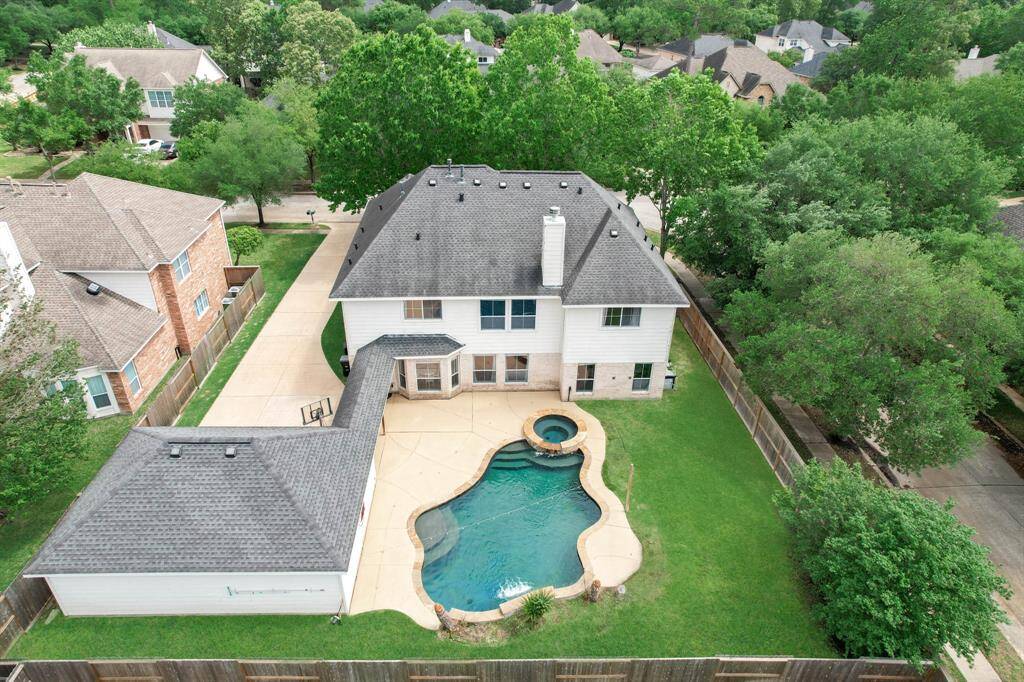 This backyard is easy to love! Privacy, lots of space to play, and a heated pool and spa.