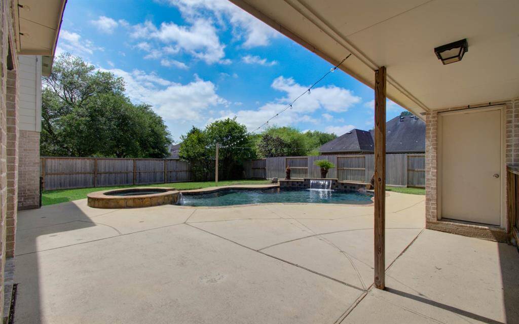 A covered walkway connects the 3 car garage to the home.