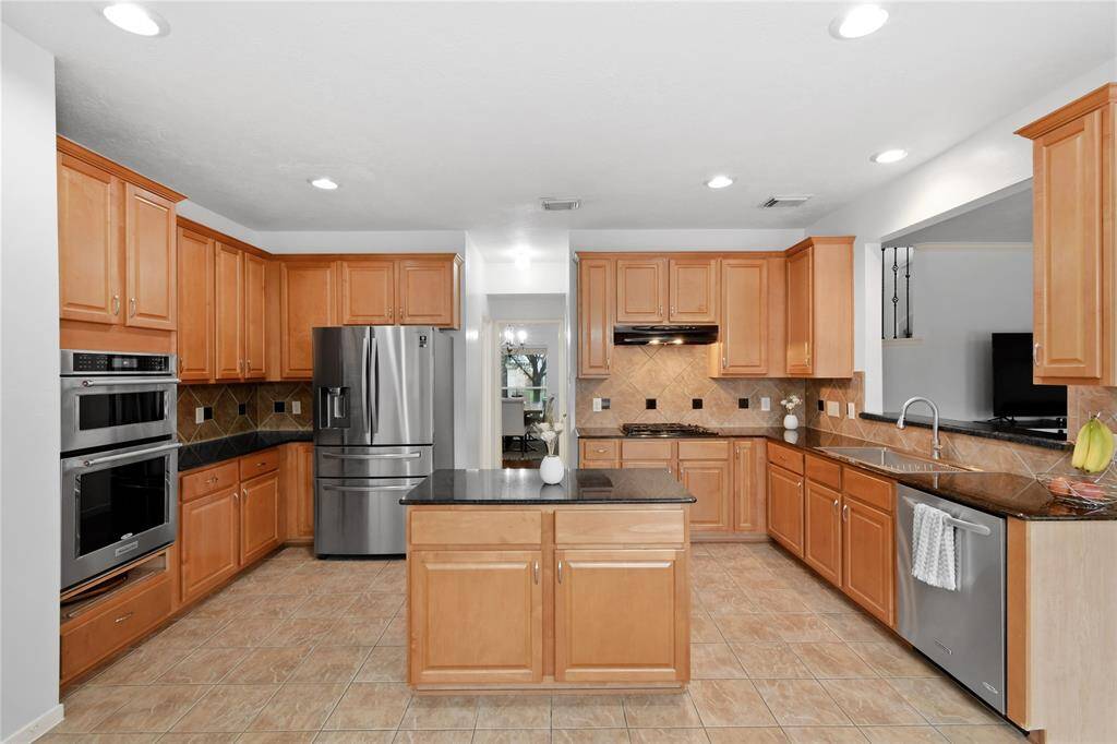 This kitchen is a delight with a center island and granite counters.