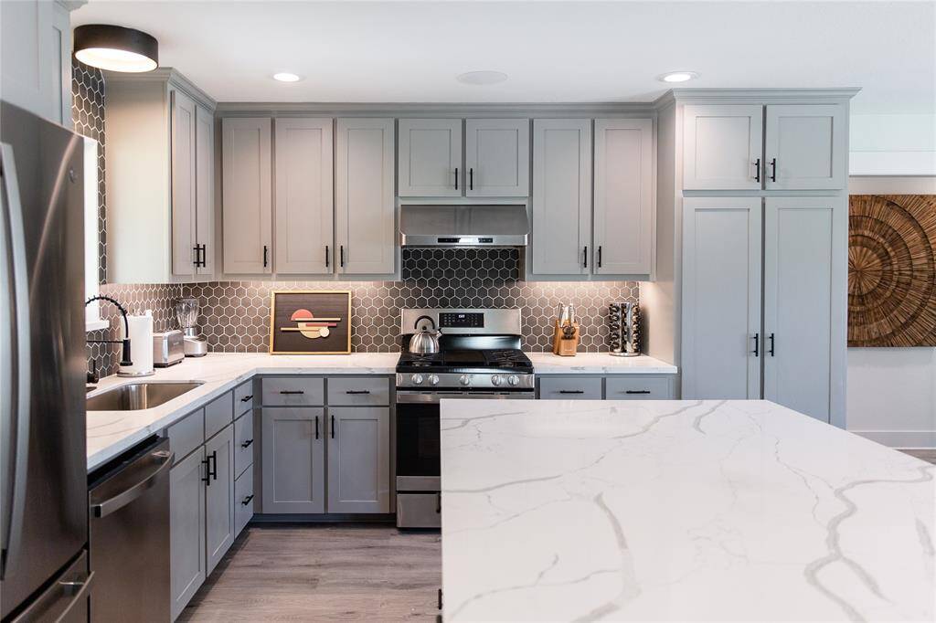 Beautiful tile and cabinets with quartz counter tops.
