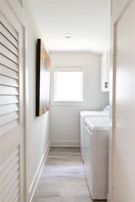 Utility room with washer, dryer and storage.