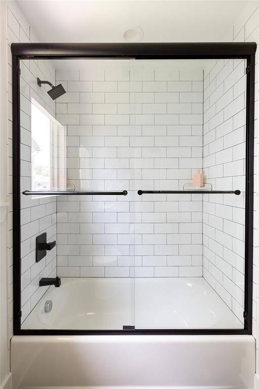Decorative tub and shower with tile.