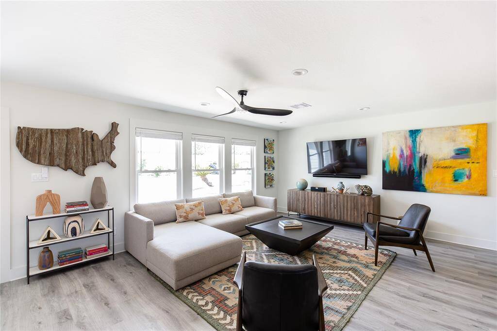 Large living space with windows bringing outside light.