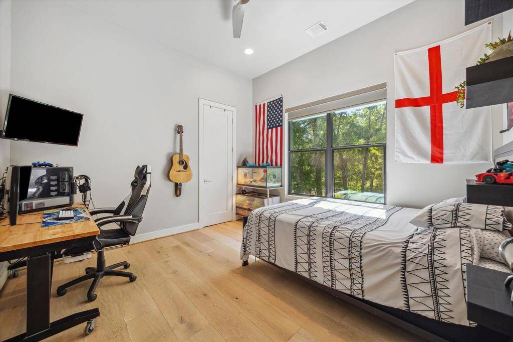 Third bedroom features a window, high ceilings, and recessed lighting.