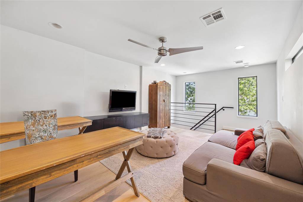 Extra room has a modern ceiling fan and recessed lighting. Perfect space for a home office or game room.