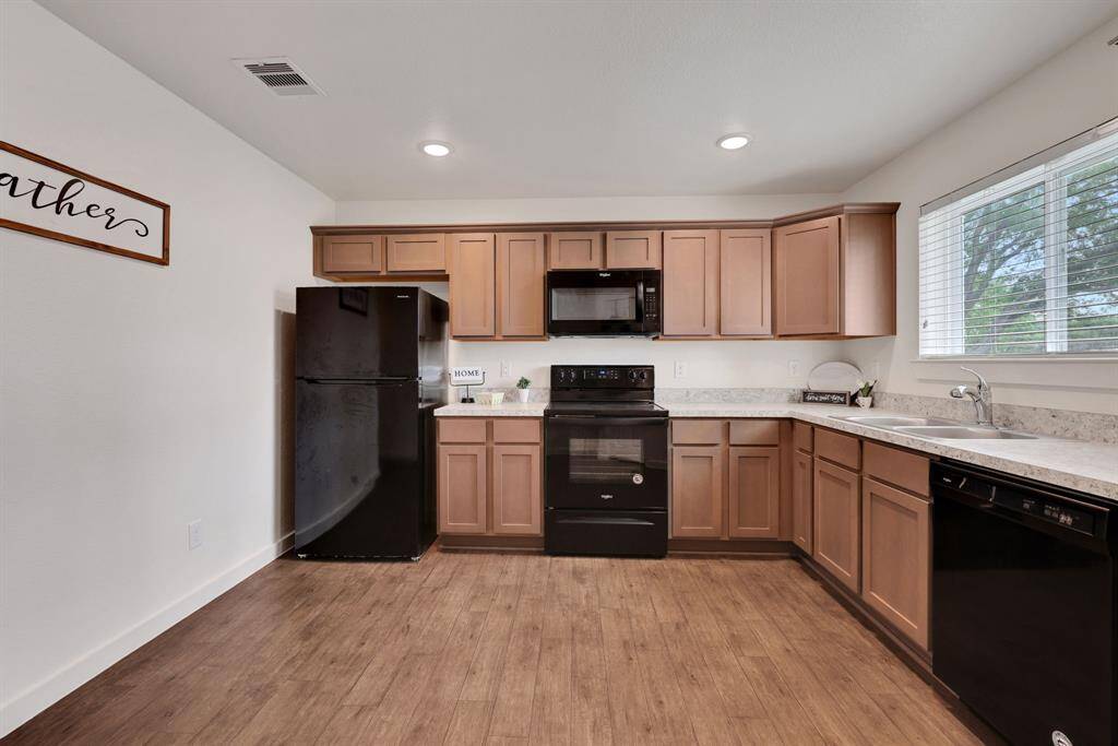 This is a model unit. The actual unit for sale has upgraded stainless appliances.