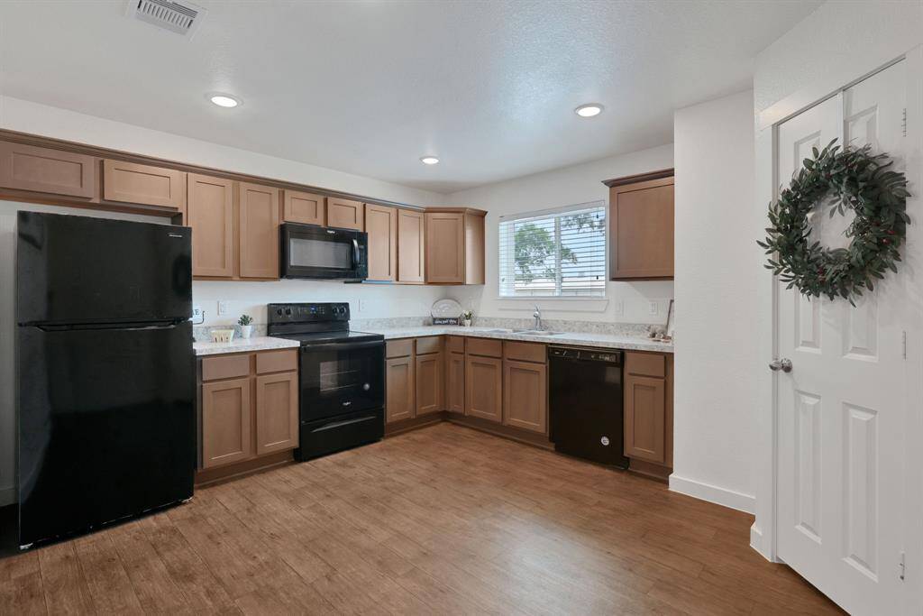 This is a model unit. The actual unit for sale has upgraded stainless appliances.