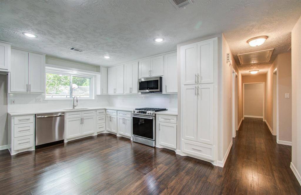 Kitchen has been tastefully updated with new cabinets, quartz counters, back-splash, LED lighting and new stainless steel appliances.