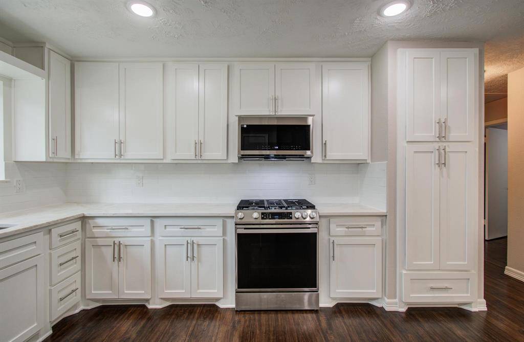 Kitchen also features door pulls on the cabinets, soft close doors and the gas range is vented out to exterior.