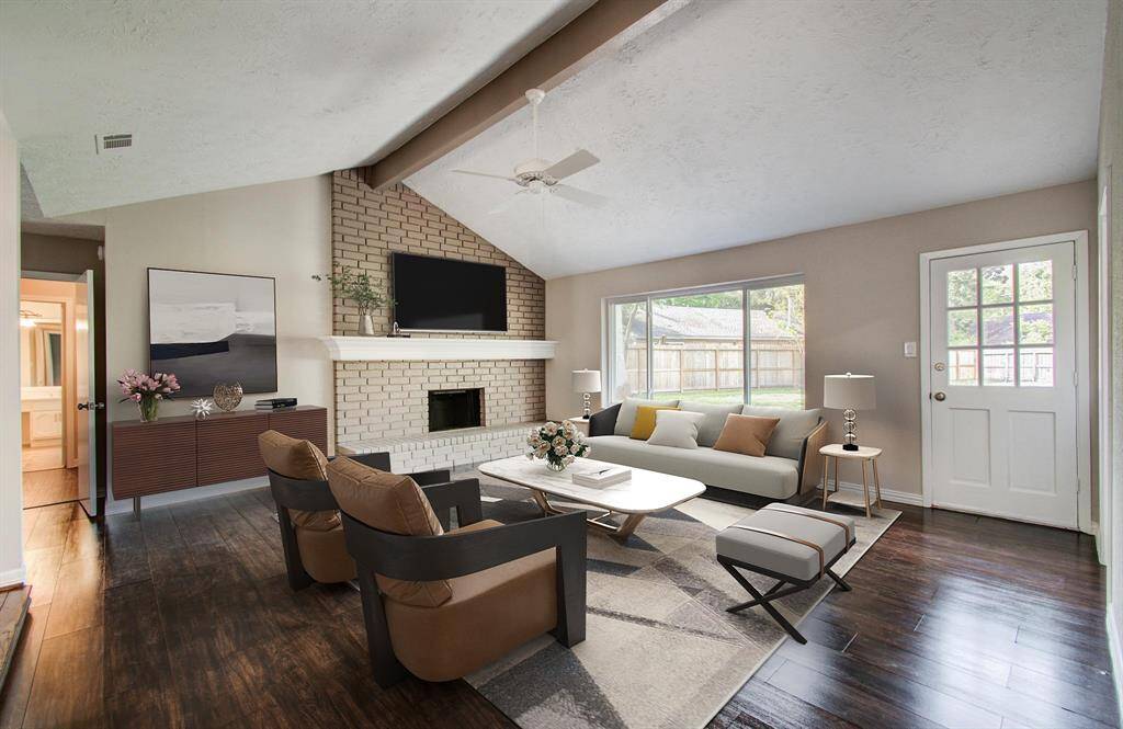 Living Room has a nice brick fireplace and has been virtually staged to show the use of space.