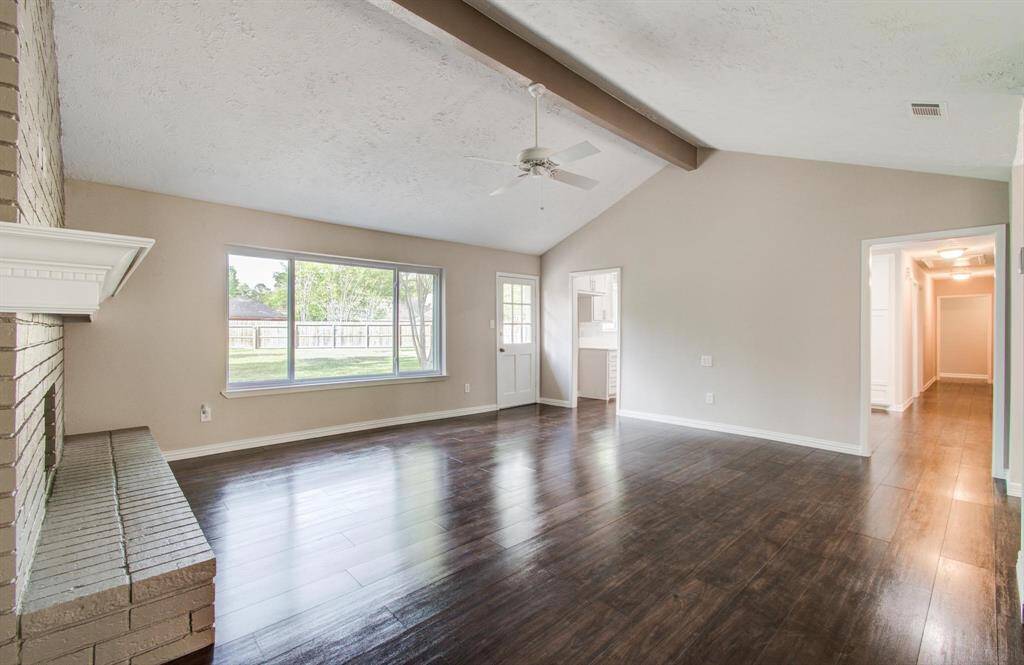 With a vaulted ceiling and large window overlooking the backyard, the spacious living room is airy and bright.