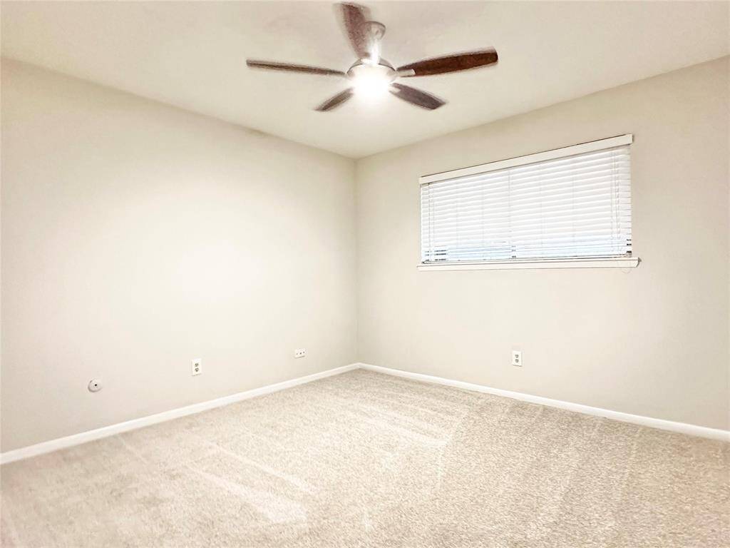 Secondary bedrooms with ceiling fans and new carpet. 2 inch blinds throughout is also a plus in this home.