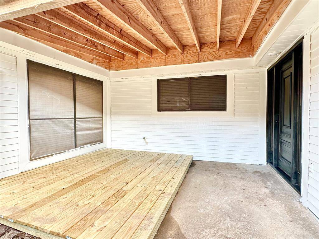 Porch has recent decking and fresh paint in exterior of house.