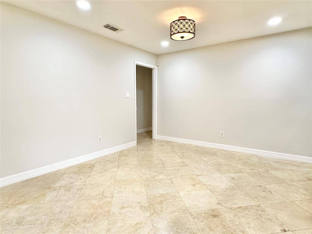 Dining area with updated lighting and upgraded fixtures throughout.