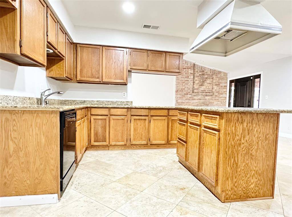 Another view of the kitchen with open concept to the living/dinning areas and kitchen island with new cooktop.