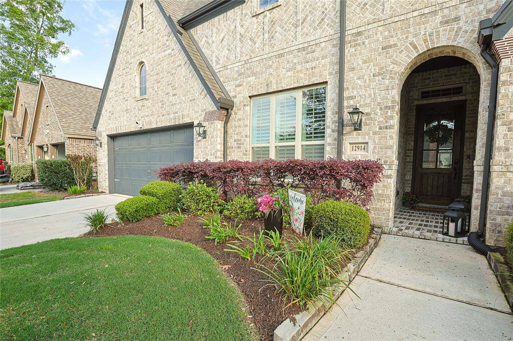 Mature landscaping and charming arched entry welcome you to your new home