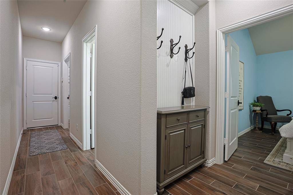 Hallway off the kitchen that leads to the laundry room and additional secondary bedroom