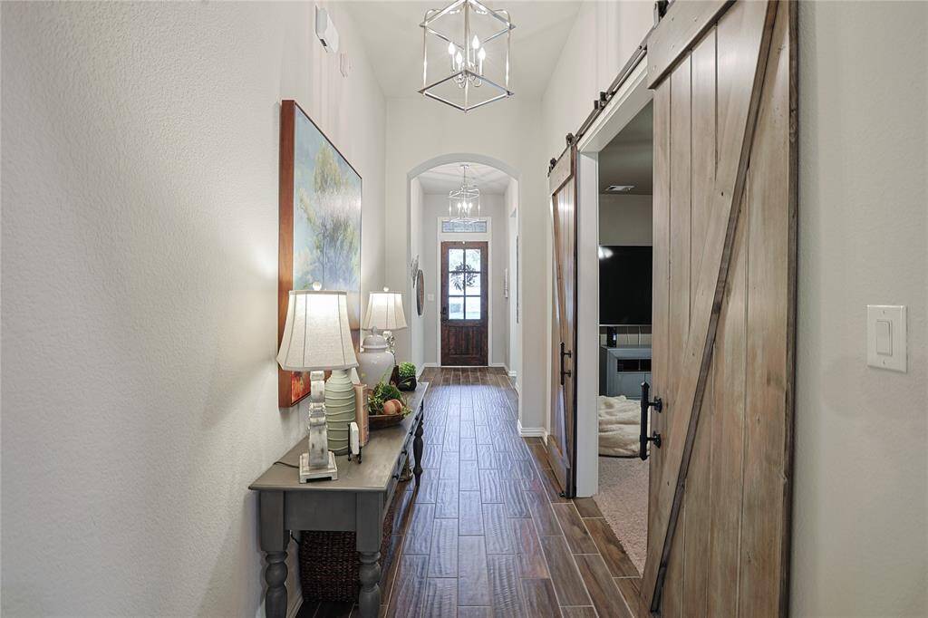Custom barn doors open to the media room