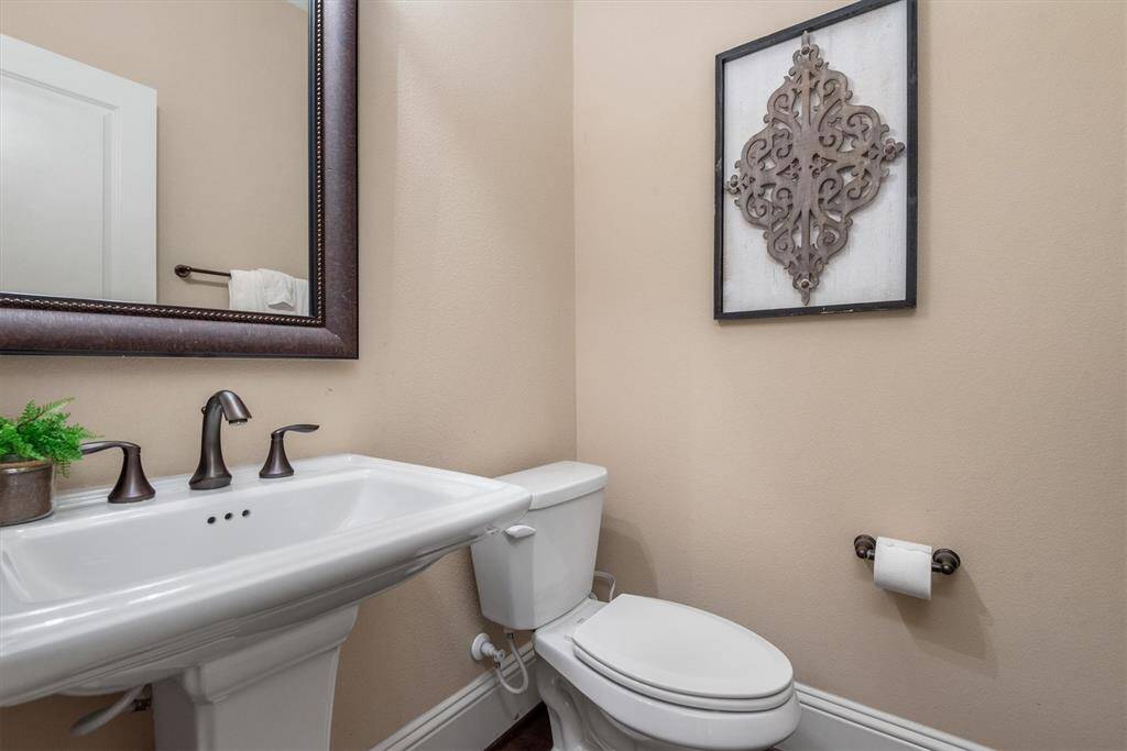 The half bath is located near the front door and away from the main living area.