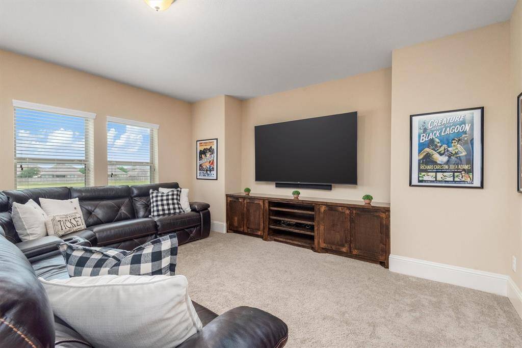 The massive game room boasts over 300 square feet.  The windows overlook the serene greenspace behind the home.