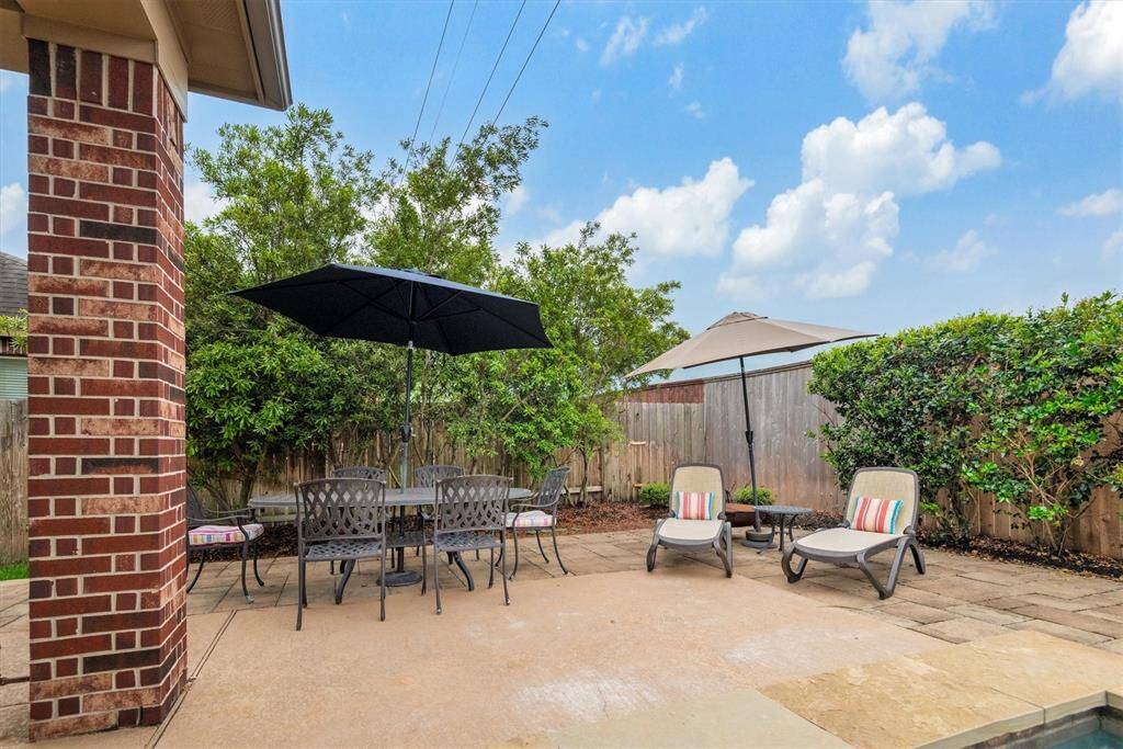 From the patio to poolside, there are plenty of areas in this yard to enjoy the outdoors.