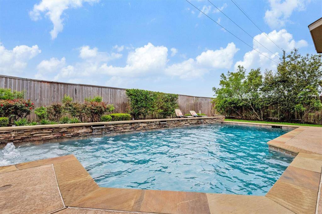 The pool has a stone stacked ledge with fountains, bubblers, travertine surround and state of the art ozone filtration.