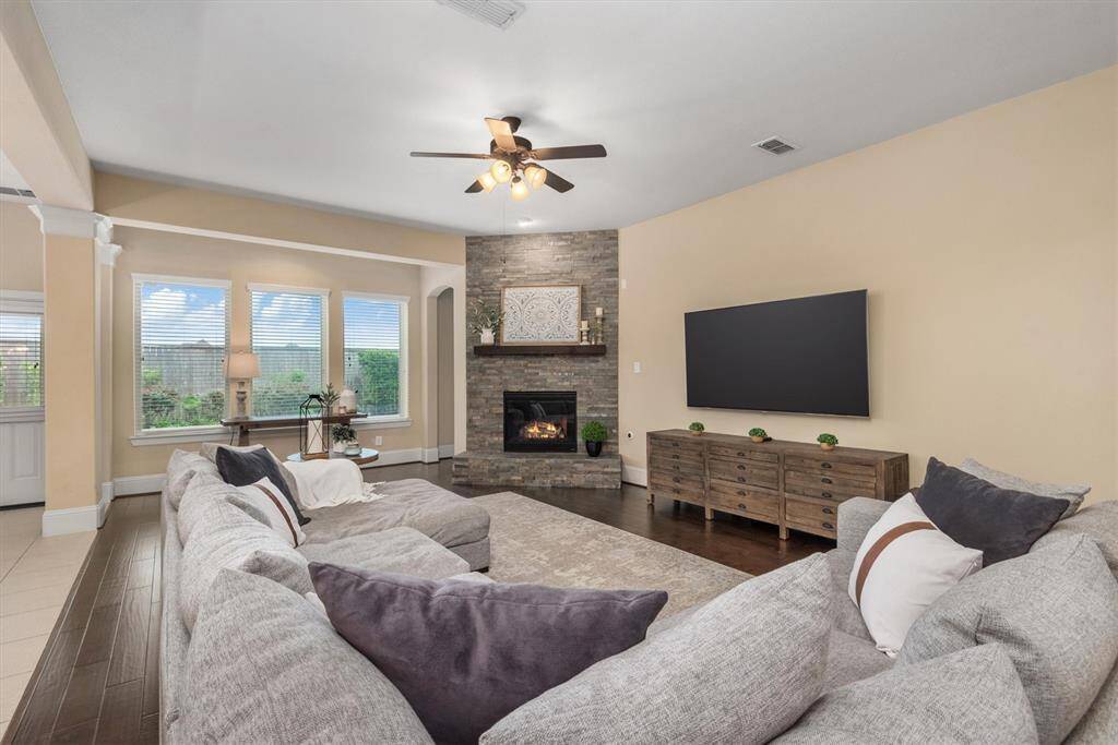 The stacked stone fireplace serves as the focal point of the living room.