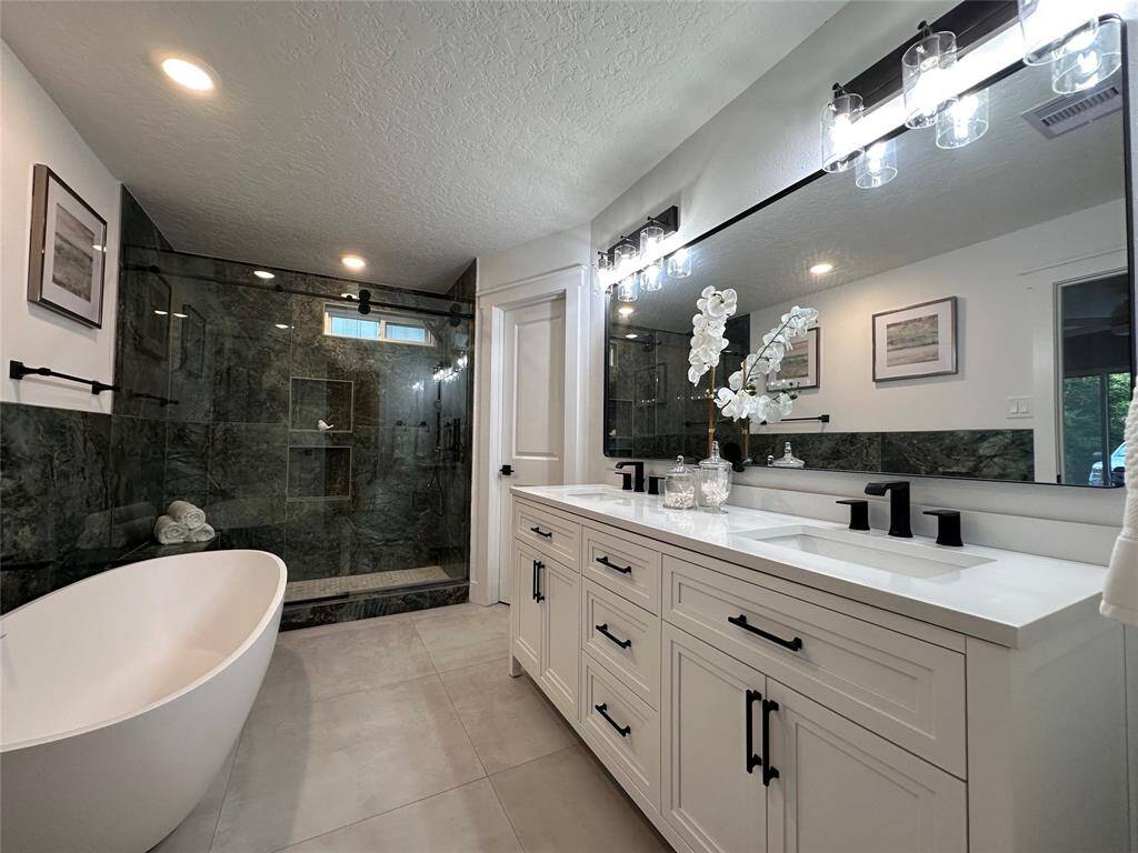 Master Bathroom with Free Standing soaking tub and a walk in shower with a built in bench
