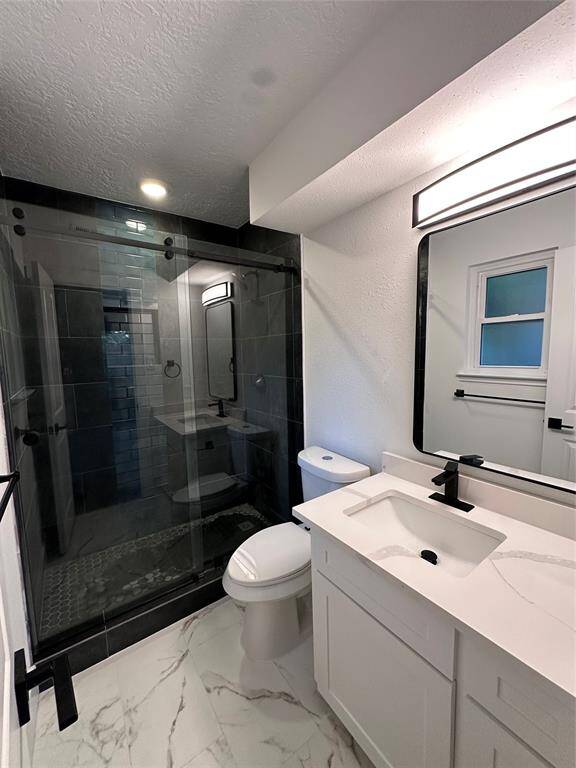 Ensuite Bathroom with walk in shower and glass sliding shower door.