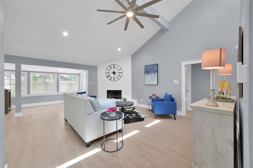 Large open plan living space with gas burning fireplace.