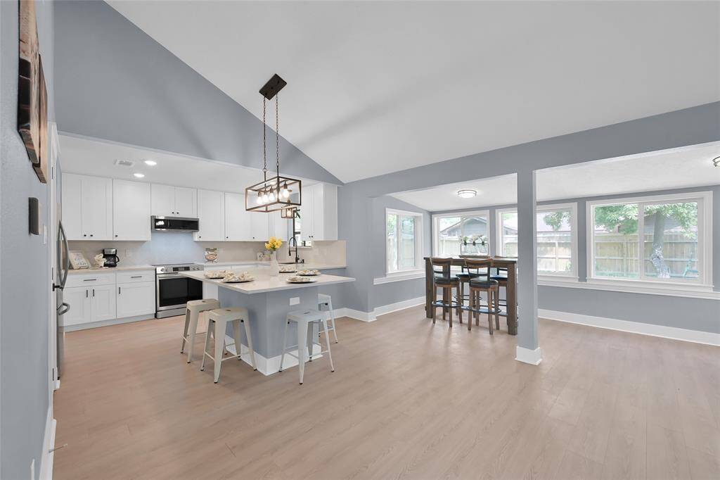 Dining area with extra space and large windows to the back yard