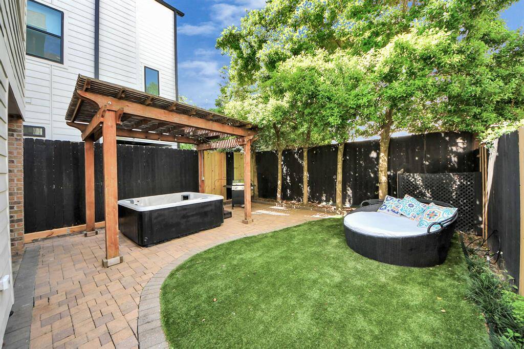 backyard with stone walkway and turf